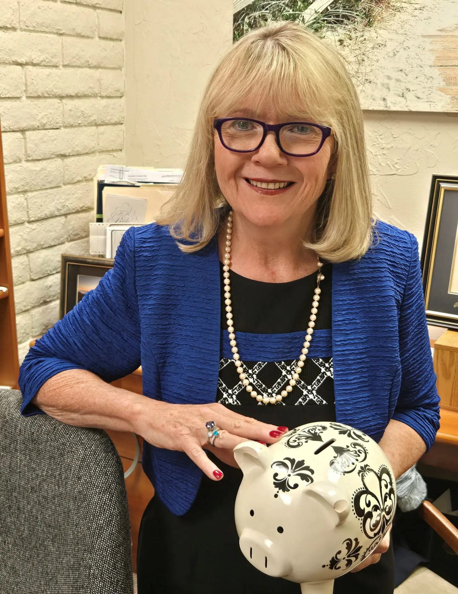 Coach Kathleen Stapleton with piggy bank - representing financial security and planning guidance